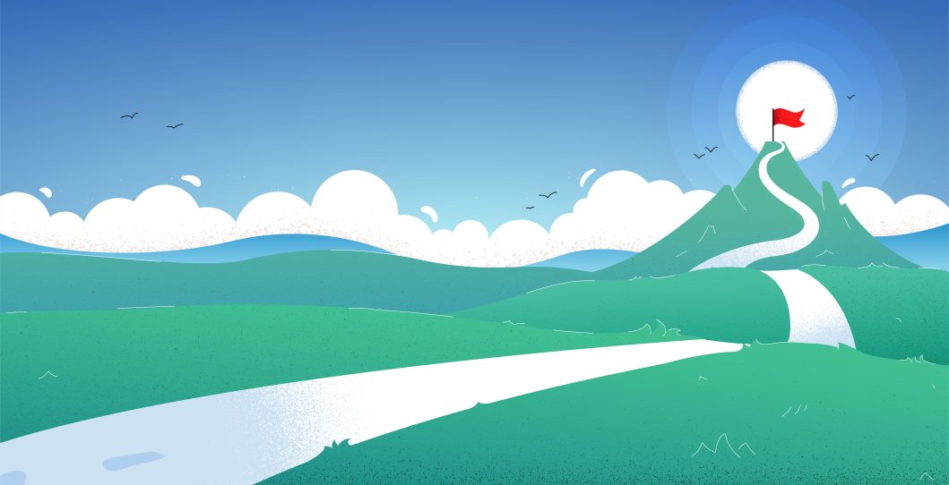 Green hillside path leading to mountain peak with red flag under clear blue sky.