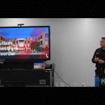 Police officer presenting autism spectrum disorder information on large screen in classroom setting.