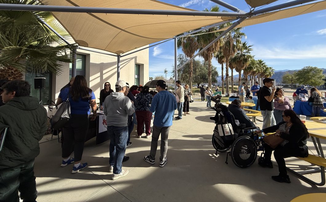 People visiting outdoor resource booths during a community wellness event.