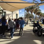 People visiting outdoor resource booths during a community wellness event.