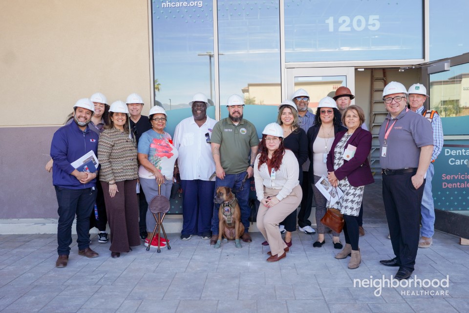Group of people wearing hard hats posing outside a Neighborhood Healthcare facility in Rialto during a hard hat tour.Group of people wearing hard hats posing outside a Neighborhood Healthcare facility in Rialto during a hard hat tour.
